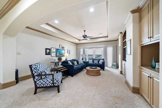 This expansive game/media room on the upper level provides convenient access to the third-floor terrace, creating an ideal space for both indoor and outdoor enjoyment | Image 29