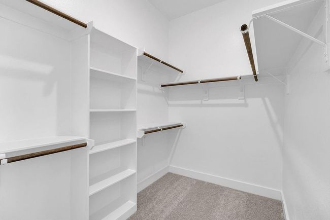 A stylish walk-in closet awaits, providing ample storage for your wardrobe and a little extra room for those cherished items. | Image 13