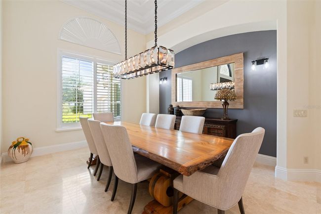 The formal dining room combines natural light and striking modern lightingto create an inviting space for stylish, memorable gatherings. | Image 13