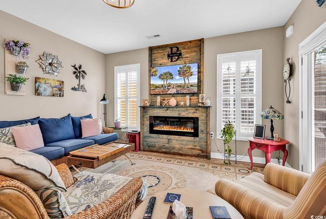 Living room with visible vents and a glass covered fireplace | Image 7