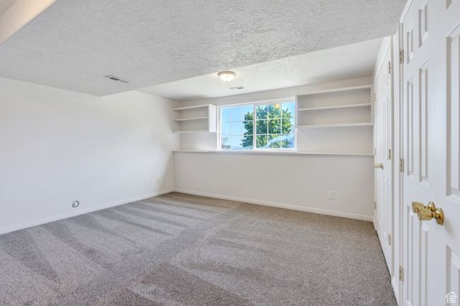 Empty room featuring carpet floors, baseboards, and a textured ceiling | Image 16