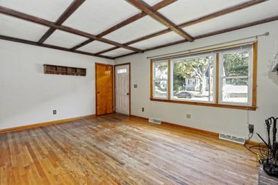 Bright and sunny living room with hardwood floors. | Image 3