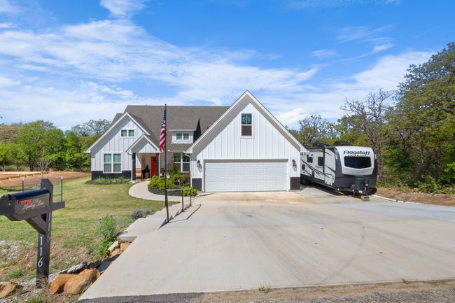 Modern inspired farmhouse with board and batten siding, driveway, a garage, and a front​​‌​​​​‌​​‌‌​‌‌​​​‌‌​​‌‌​‌​​​​​‌ lawn | Image 4