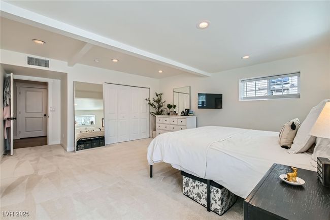 Bedroom featuring beamed ceiling, recessed lighting, light carpet, and a closet | Image 18