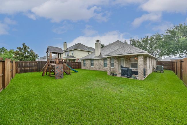 Large backyard with covered patio, great for evening grilling. | Image 17