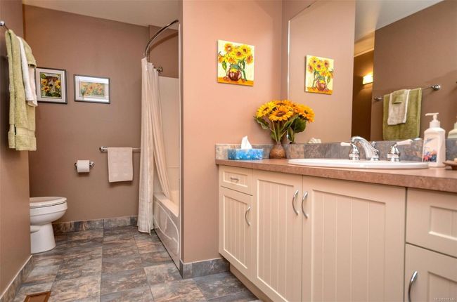 Full bathroom with toilet, tile flooring, shower/bath combo and vanity | Image 21