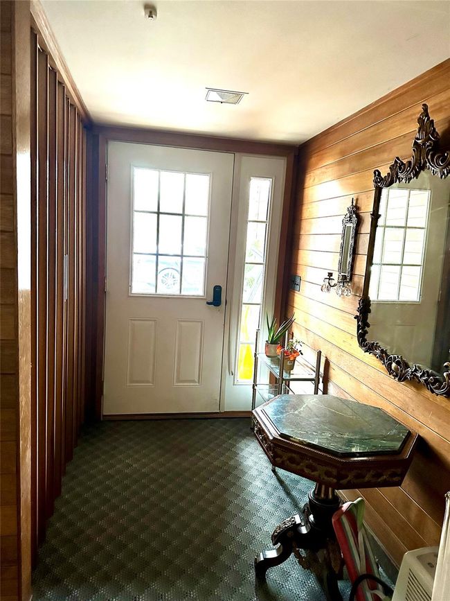 Doorway featuring wood walls and carpet floors | Image 26