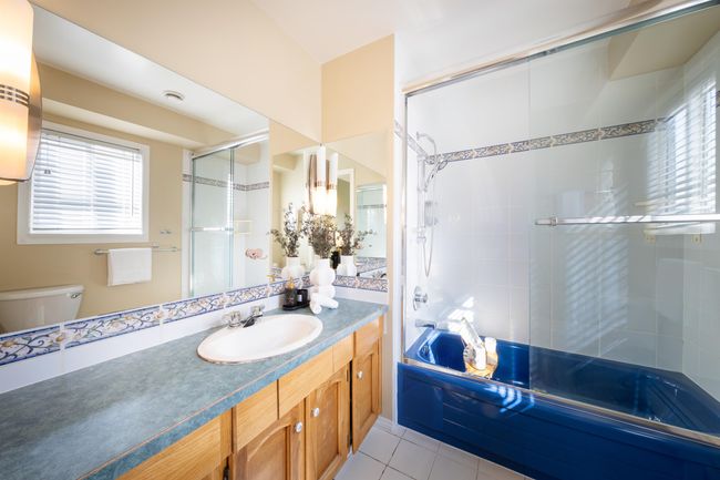 Bathroom featuring plenty of natural light, toilet, tile patterned flooring, and vanity | Image 32