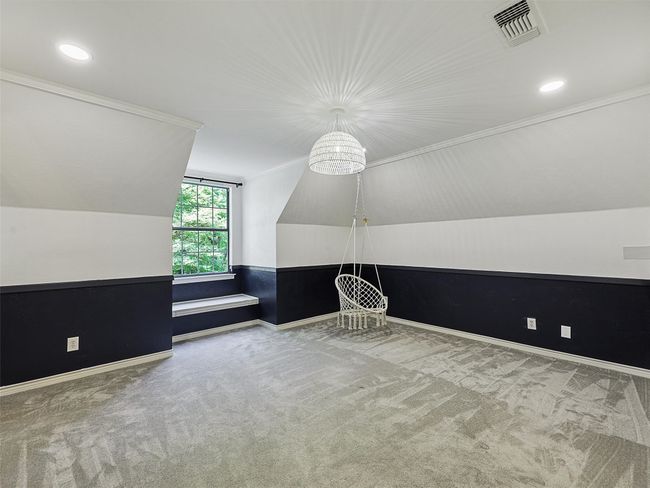 Additional living space featuring vaulted ceiling, carpet, visible vents, and baseboards | Image 26