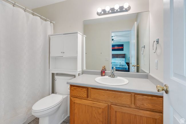 Ensuite bathroom with vanity, a ceiling fan, and curtained shower | Image 10