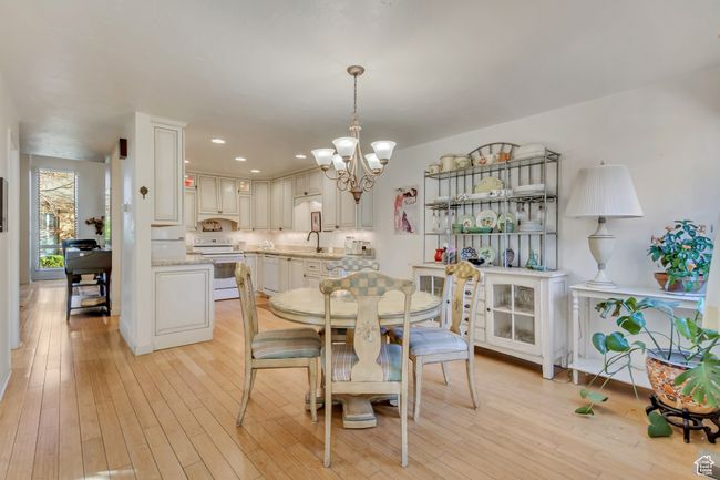 Dining room with recessed lighting, light wood finished floors, and an inviting chandelier | Image 5