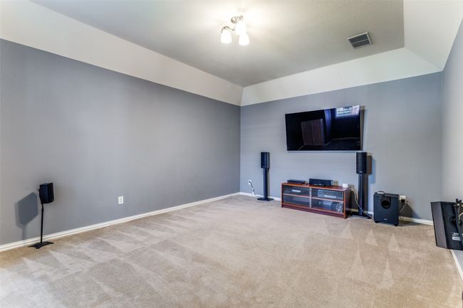 Unfurnished living room featuring carpet flooring and lofted ceiling | Image 20