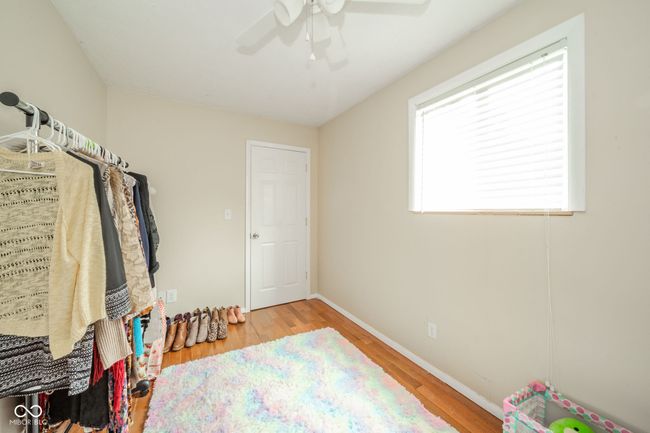 spacious closet featuring a ceiling fan and wood finished floors | Image 23