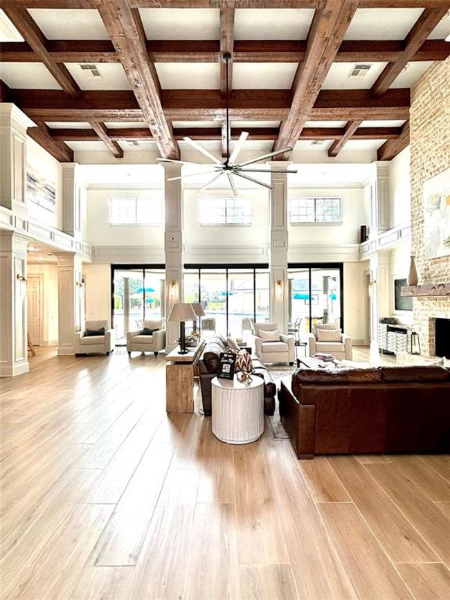 The elegant Clubhouse at The Falls at Imperial Oaks offers a warm, inviting space for residents to gather, relax, and host private events—featuring soaring ceilings, stylish seating, and direct access to outdoor amenities. | Image 49