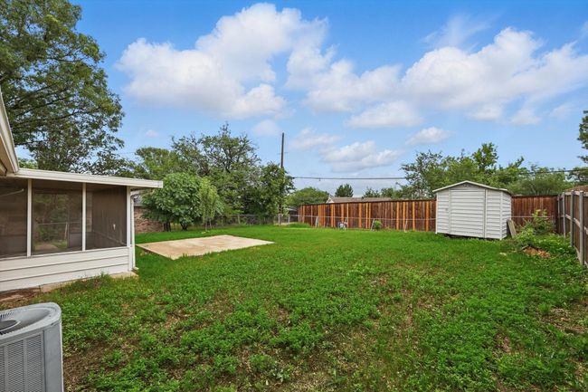 View of yard with central AC, a sunroom, and a patio area | Image 21