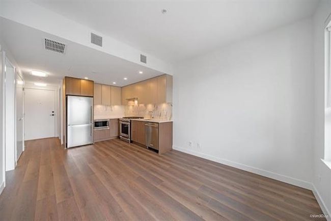 Kitchen featuring stainless steel appliances, dark wood-style floors, tasteful backsplash, light countertops, and recessed lighting | Image 6