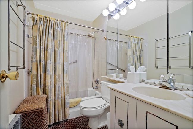 Full bathroom featuring toilet, vanity, and shower / bathtub combination with curtain | Image 19