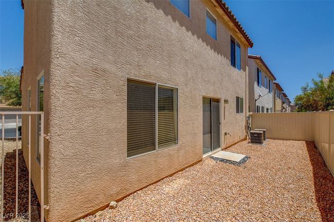 Back of house with central AC, a fenced backyard, and stucco siding | Image 24