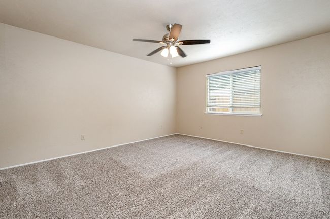 Carpeted spare room with baseboards and ceiling fan | Image 15