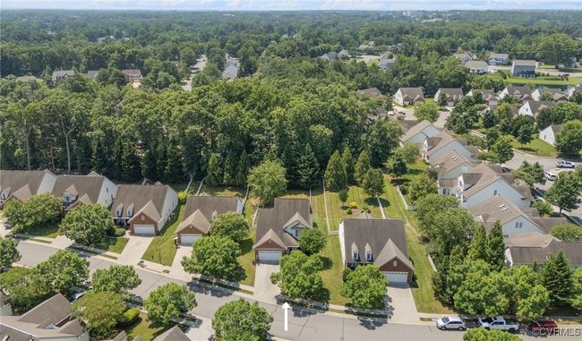 Aerial view of residential area featuring a heavily wooded area | Image 46