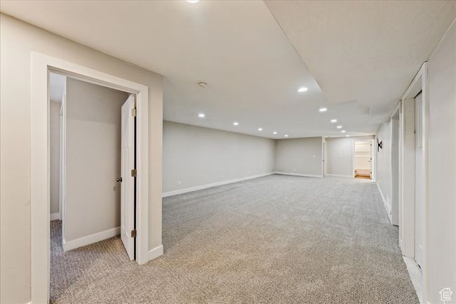 Finished basement featuring baseboards, recessed lighting, and light colored carpet | Image 39