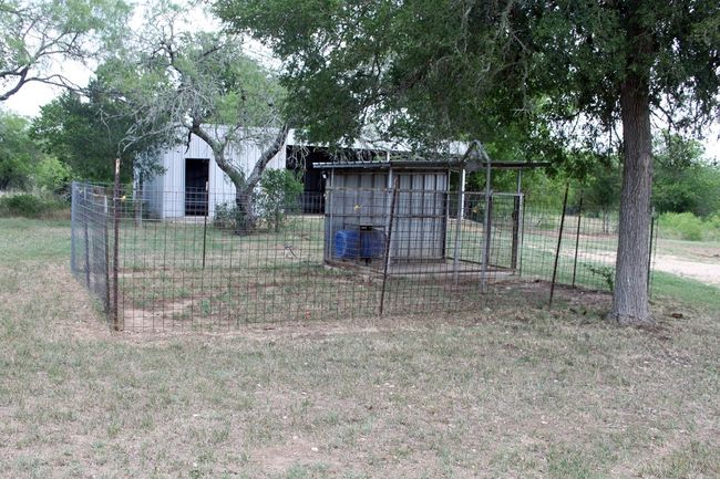 View of yard featuring an outdoor structure, fence, and cooling unit | Image 9