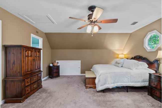 Bedroom with lofted ceiling, carpet, and a ceiling fan | Image 31