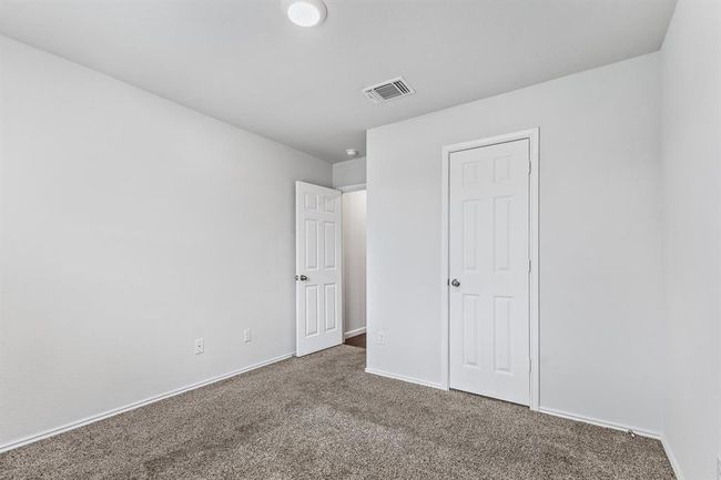 Unfurnished bedroom featuring carpet floors and baseboards | Image 13