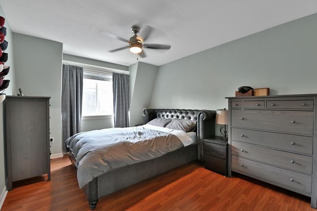 Bedroom featuring baseboards, a ceiling fan, and dark wood finished floors | Image 23