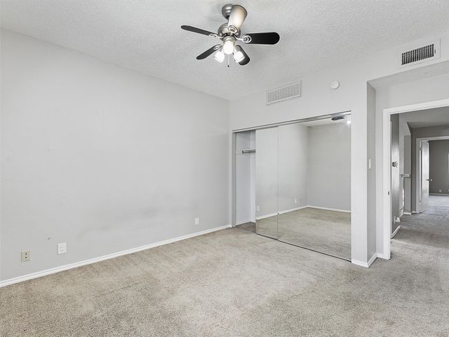 Bedroom with carpet & mirrored closet. | Image 29