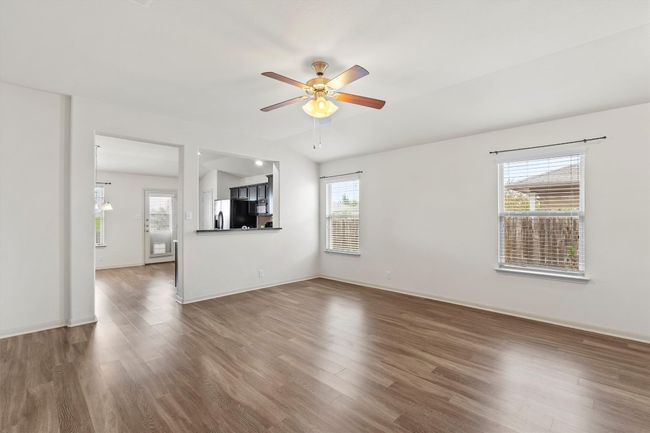 The two rooms feel as one with the kitchen counter overlooking into the living room. Lots of windows allow for natural light. | Image 5