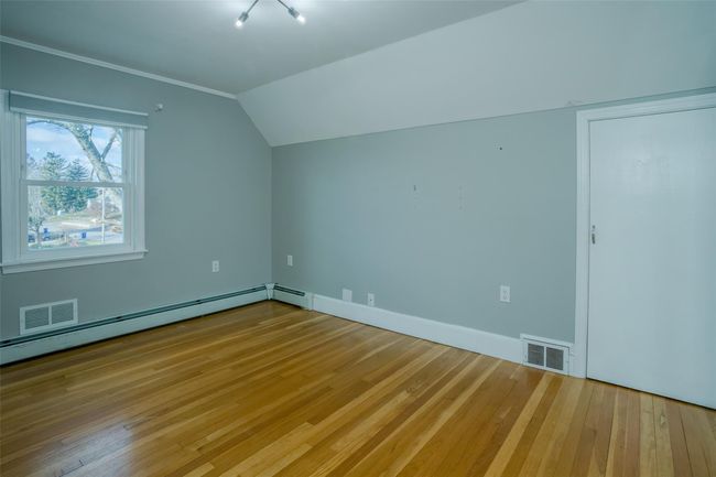 Bonus room featuring hardwood / wood-style floors, baseboard heating, and lofted ceiling | Image 15