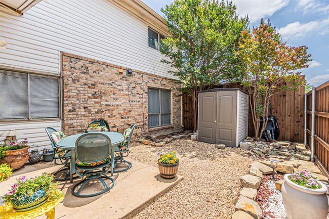 Fenced backyard with a patio and outdoor dining area | Image 22