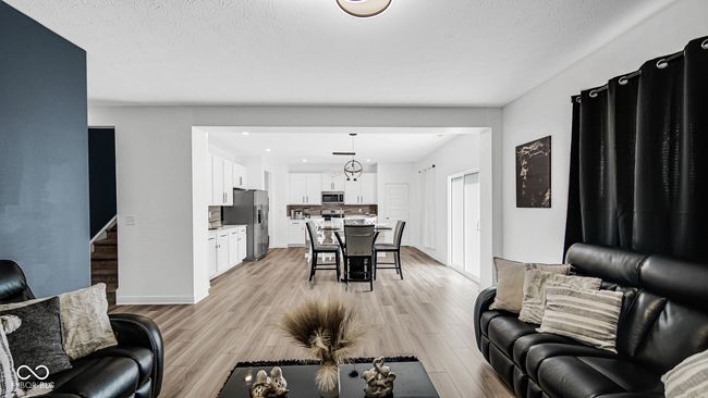 living area featuring light wood-style flooring and baseboards | Image 15