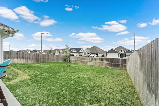 View of yard featuring a fenced backyard and a residential view | Image 28