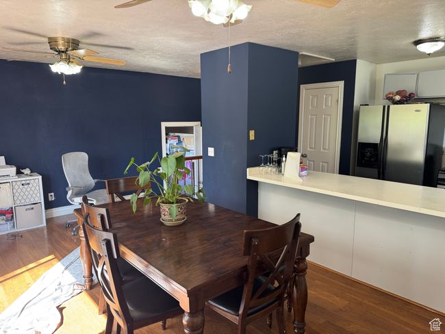 Dining room featuring a ceiling fan, wood finished floors, and a textured ceiling | Image 6