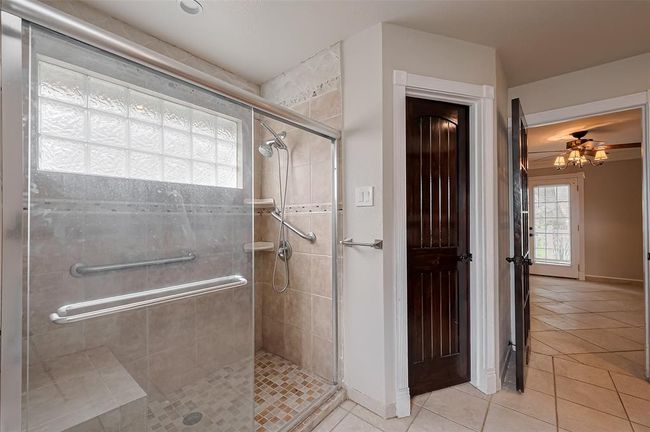 This primary bath is both elegant and functional, featuring a large walk-in shower, double sinks, and rich finishes that blend comfort with timeless design. | Image 29