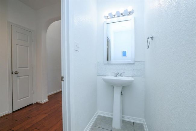 Located off the foyer is the updated powder bath. | Image 9