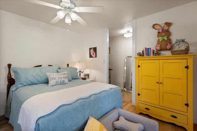 Bedroom with light wood-type flooring and ceiling fan | Image 36