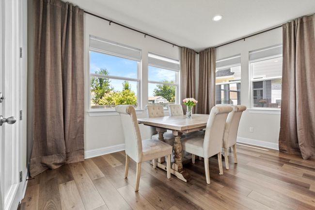 Dining room with light wood-style flooring and recessed lighting | Image 6