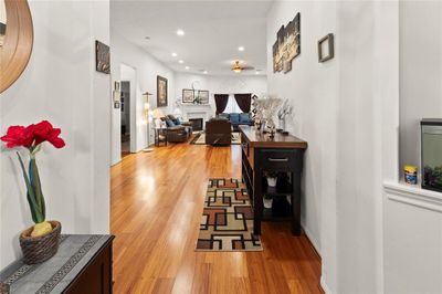 Welcoming entrance with elegant engineered wood flooring and an open, airy floor plan. | Image 3