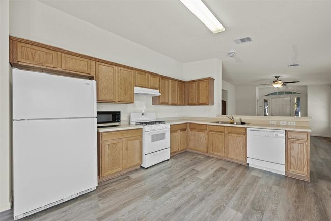 The kitchen features a versatile neutral palette, ready to enjoy as-is or personalize it with stainless steel appliances, stone countertops, and a stylish backsplash to make it uniquely yours. | Image 10