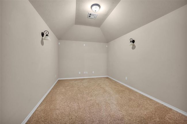 Transform your entertainment experience in this cozy media room, featuring plush carpeting and elegant wall sconces. | Image 34