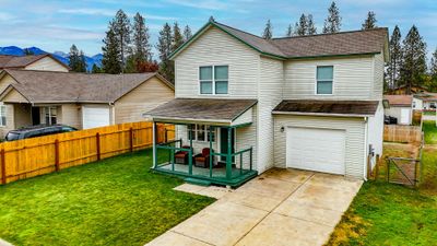 View of front facade featuring a front lawn and a garage | Image 2