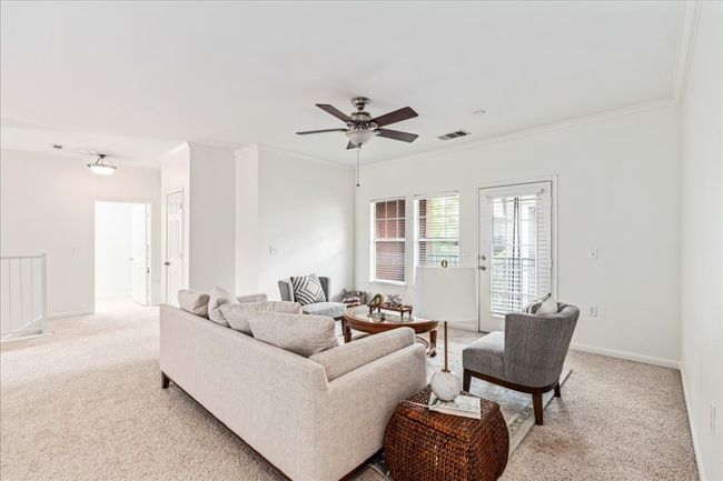 Large windows and a glass door allow natural light to flood in. | Image 4
