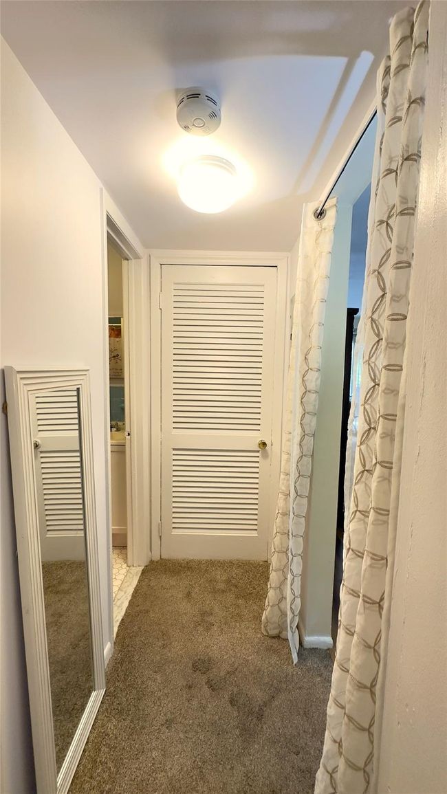 Hall featuring carpet floors, utility closet | Image 9