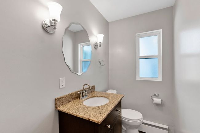 Unfurnished bedroom featuring light wood-style floors, connected bathroom, and baseboards | Image 20
