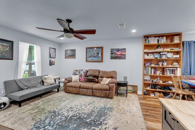 Living room featuring ceiling fan, light wood finished floors, and recessed lighting | Image 10