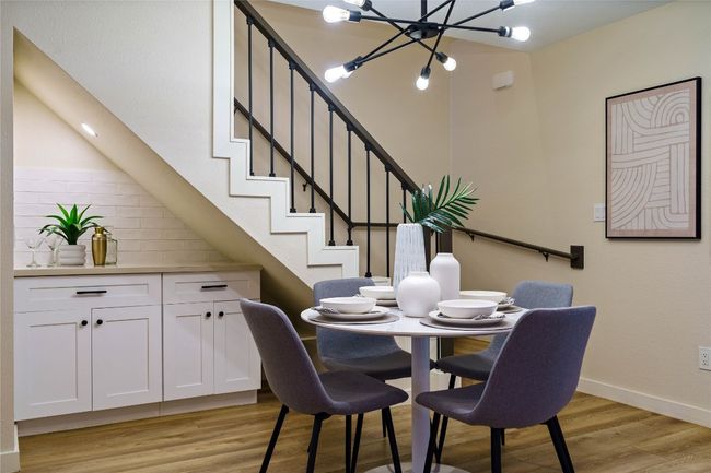 Dining space with stairs, baseboards, a chandelier, and light wood-style floors | Image 18
