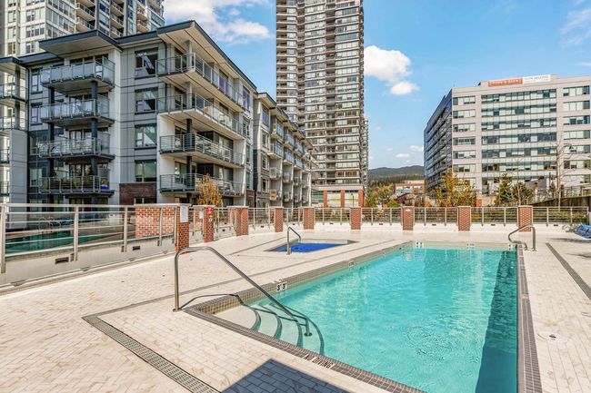 Community pool with fence and a patio area | Image 37